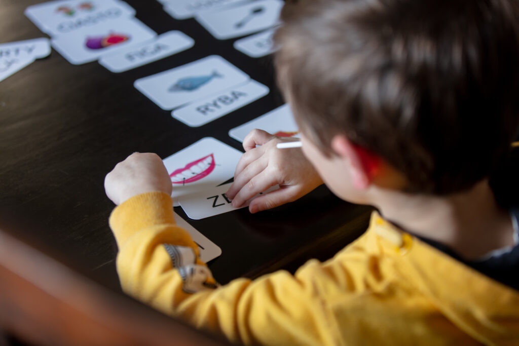 A child learning words from picture cards